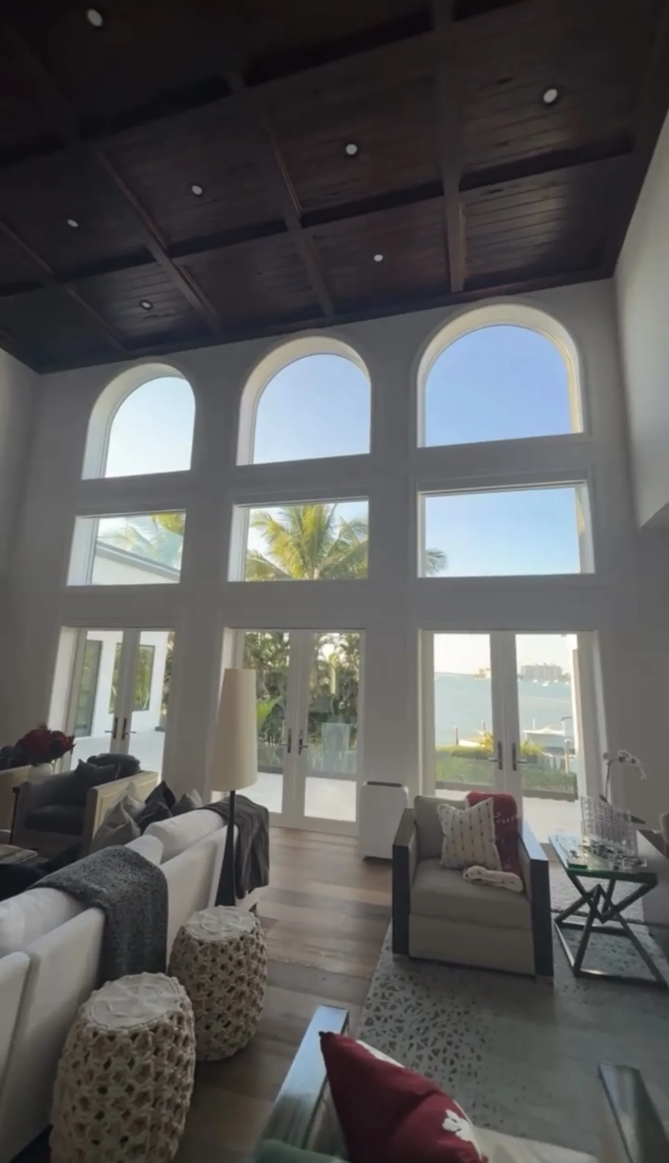 Sunlit interior with tall arched windows framing a Sarasota bay view