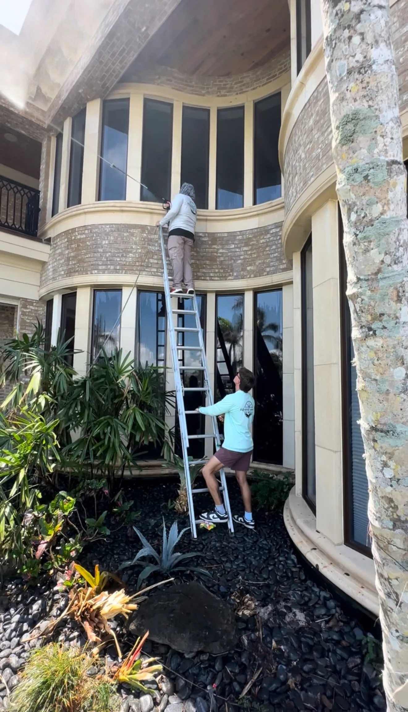 The Sunday Cleaning team cleaning windows on a Sarasota mansion